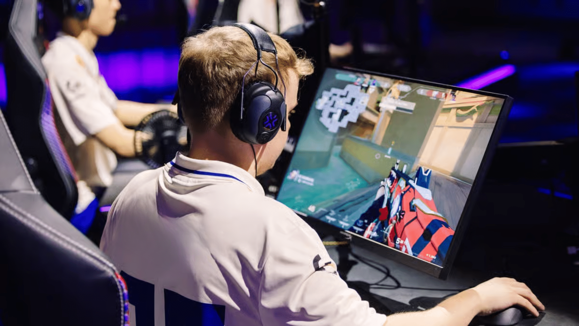 Player at a neon-lit battlestation in the middle of a round
